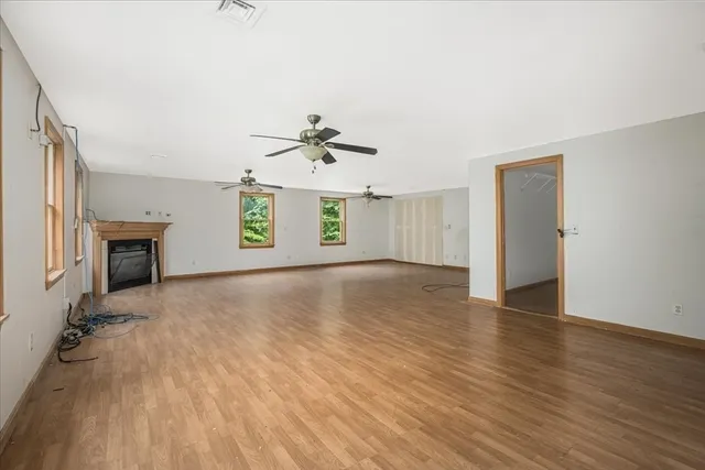 wooden floor in an empty room with a window