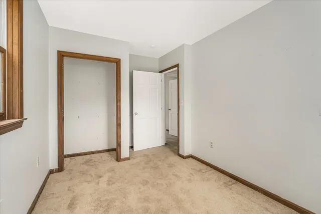 an empty room with closet area