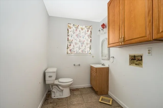 a bathroom with a toilet a sink and a window