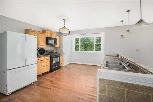 a kitchen with a refrigerator and a sink
