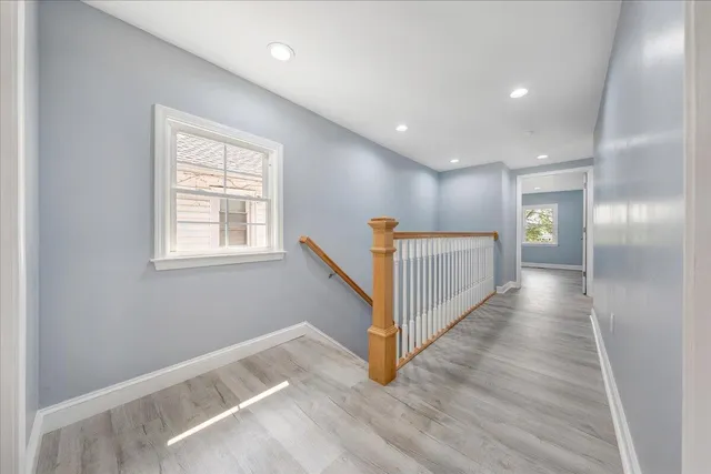 a view of a hallway with wooden floor