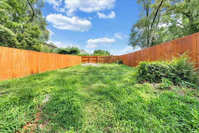 a view of yard with swimming pool and green space