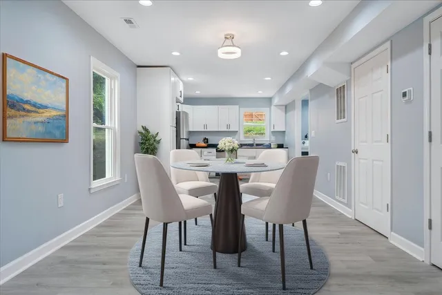 a view of a dining room with furniture and wooden floor