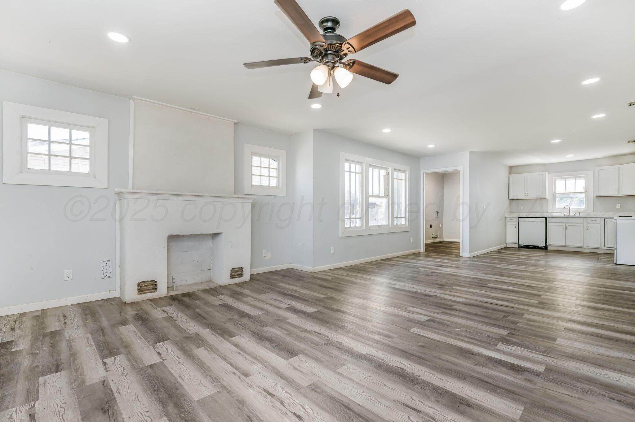 313 South Fairmont Street Amarillo, TX 79106 - Photo 4 of 15 a view of empty room with wooden floor and fan