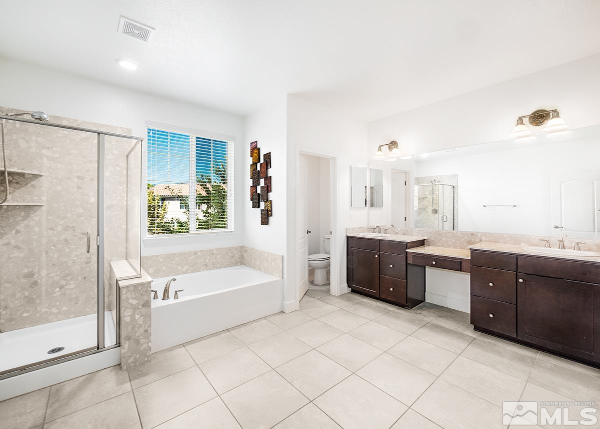 10843 Walnut Ridge Drive Reno, NV 89521 - Photo 1 of 26 a large bathroom with a tub sink shower and mirror