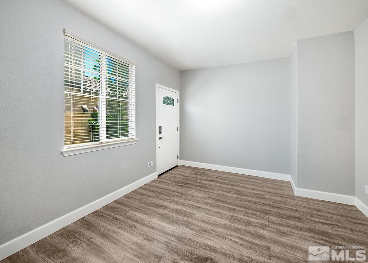 10843 Walnut Ridge Drive Reno, NV 89521 - Photo 16 of 26 a view of an empty room with wooden floor and a window