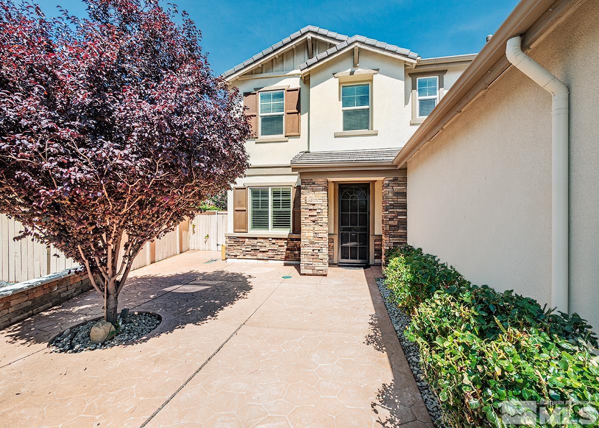 10843 Walnut Ridge Drive Reno, NV 89521 - Photo 2 of 26 a front view of a house with a yard and garage