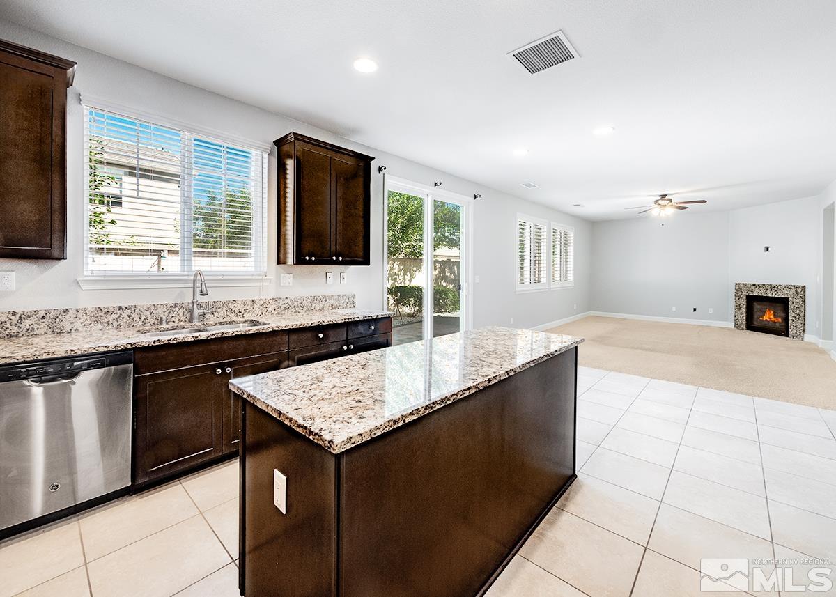 10843 Walnut Ridge Drive Reno, NV 89521 - Photo 5 of 26 a kitchen with granite countertop a sink and a stove