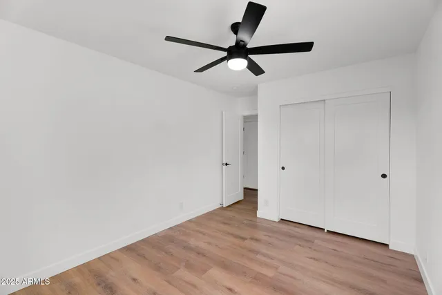 a view of a room with wooden floor and white walls