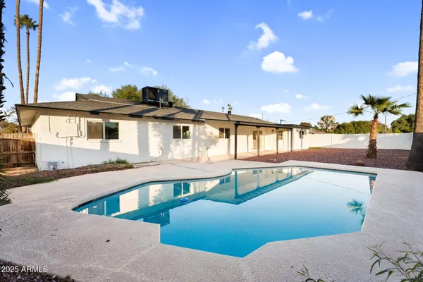 a view of a swimming pool with an outdoor seating