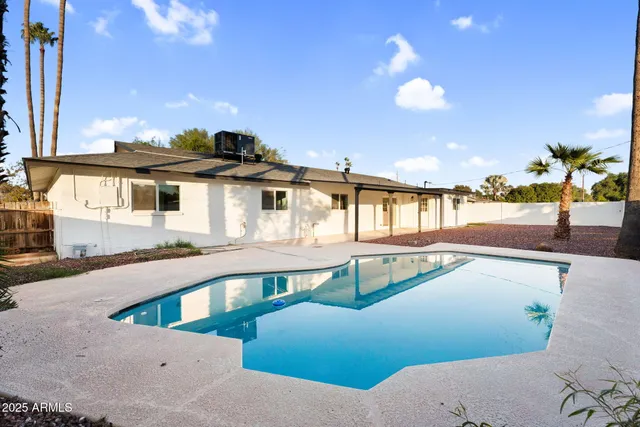 a view of a swimming pool with an outdoor seating