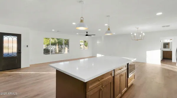 an open kitchen with a sink and breakfast area