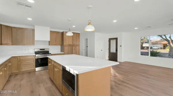 a kitchen with a stove a sink and a refrigerator