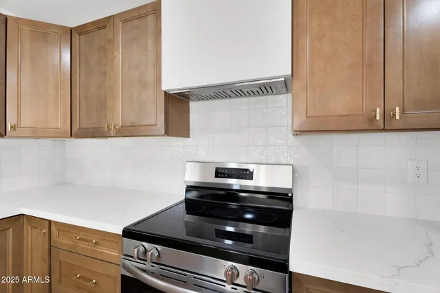 a kitchen with wooden cabinets and a stove top oven