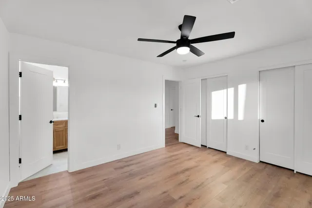 a view of a livingroom with wooden floor and white walls
