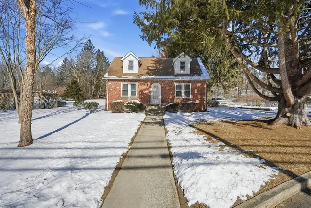 a view of a house with a yard covered with snow in front of it