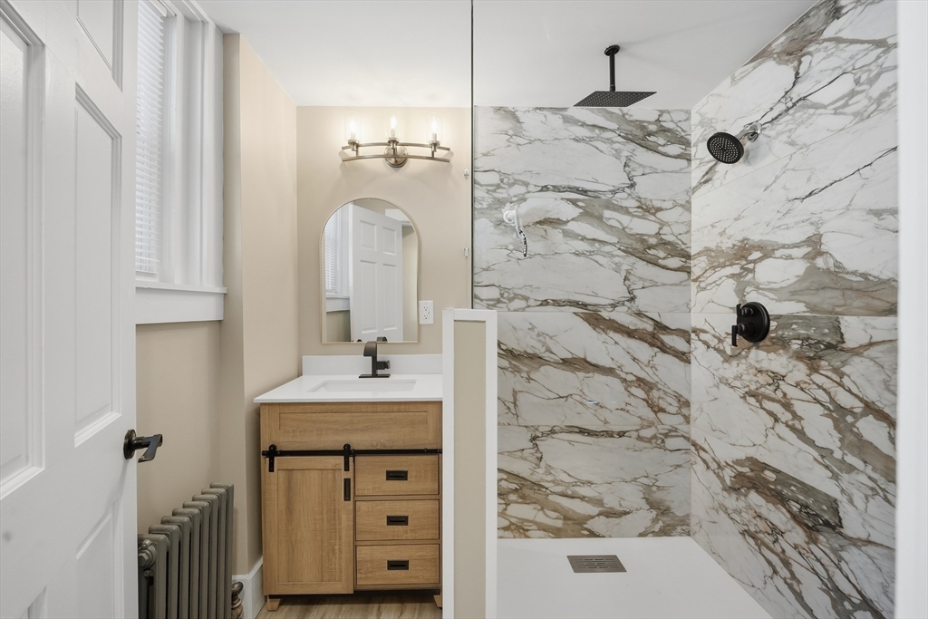 3076 Boston Road Wilbraham, MA 01095 - Photo 16 of 42 a bathroom with a sink mirror and shower