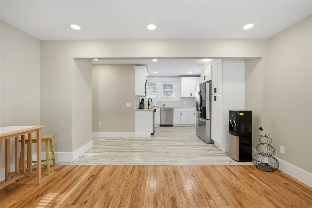 3076 Boston Road Wilbraham, MA 01095 - Photo 7 of 42 a view of a kitchen with wooden floor and a refrigerator