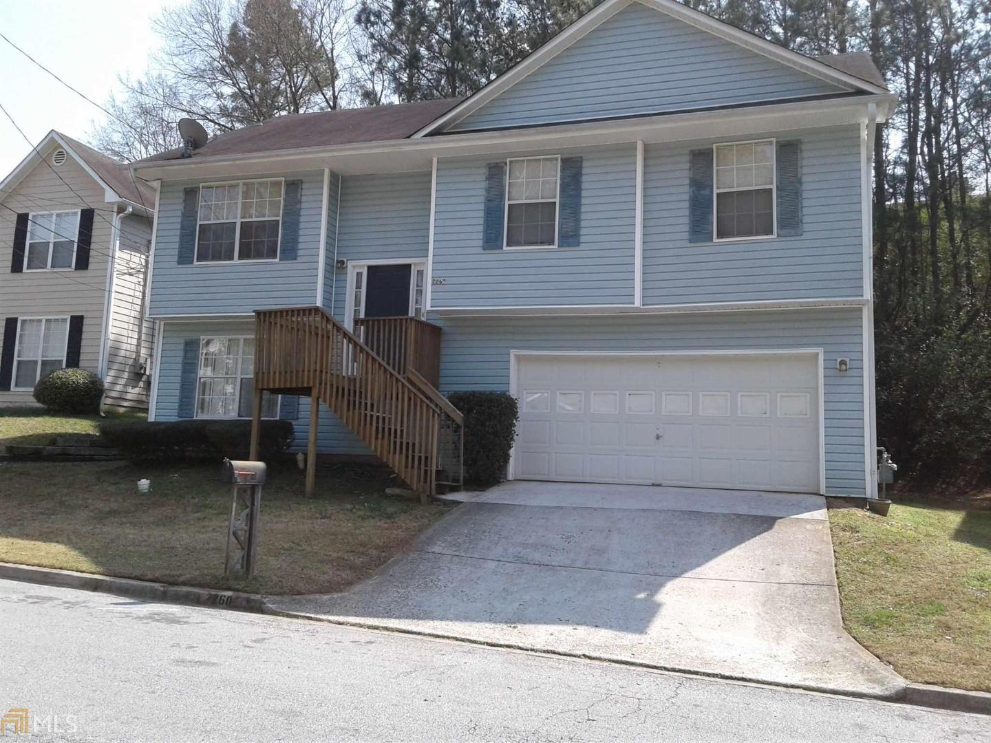a front view of a house with parking space