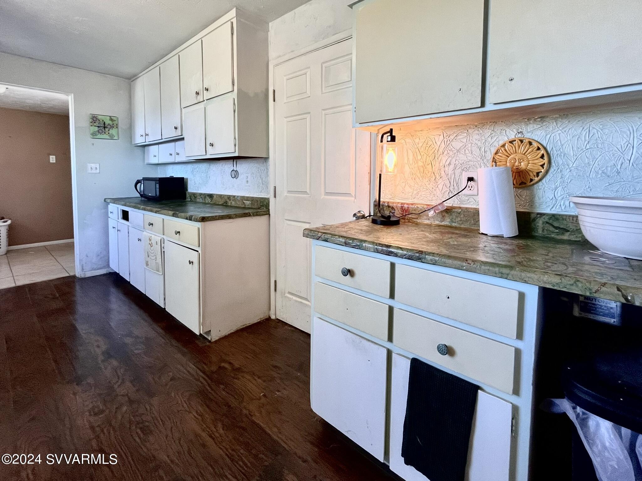 4545 North Drifting Sands Road Rimrock, AZ 86335 - Photo 17 of 52 a kitchen with granite countertop white cabinets and a stove