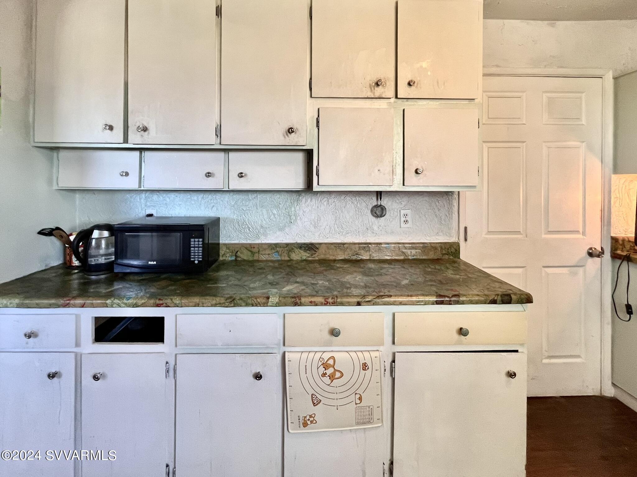 4545 North Drifting Sands Road Rimrock, AZ 86335 - Photo 20 of 52 a kitchen with granite countertop a stove a sink and a white cabinets