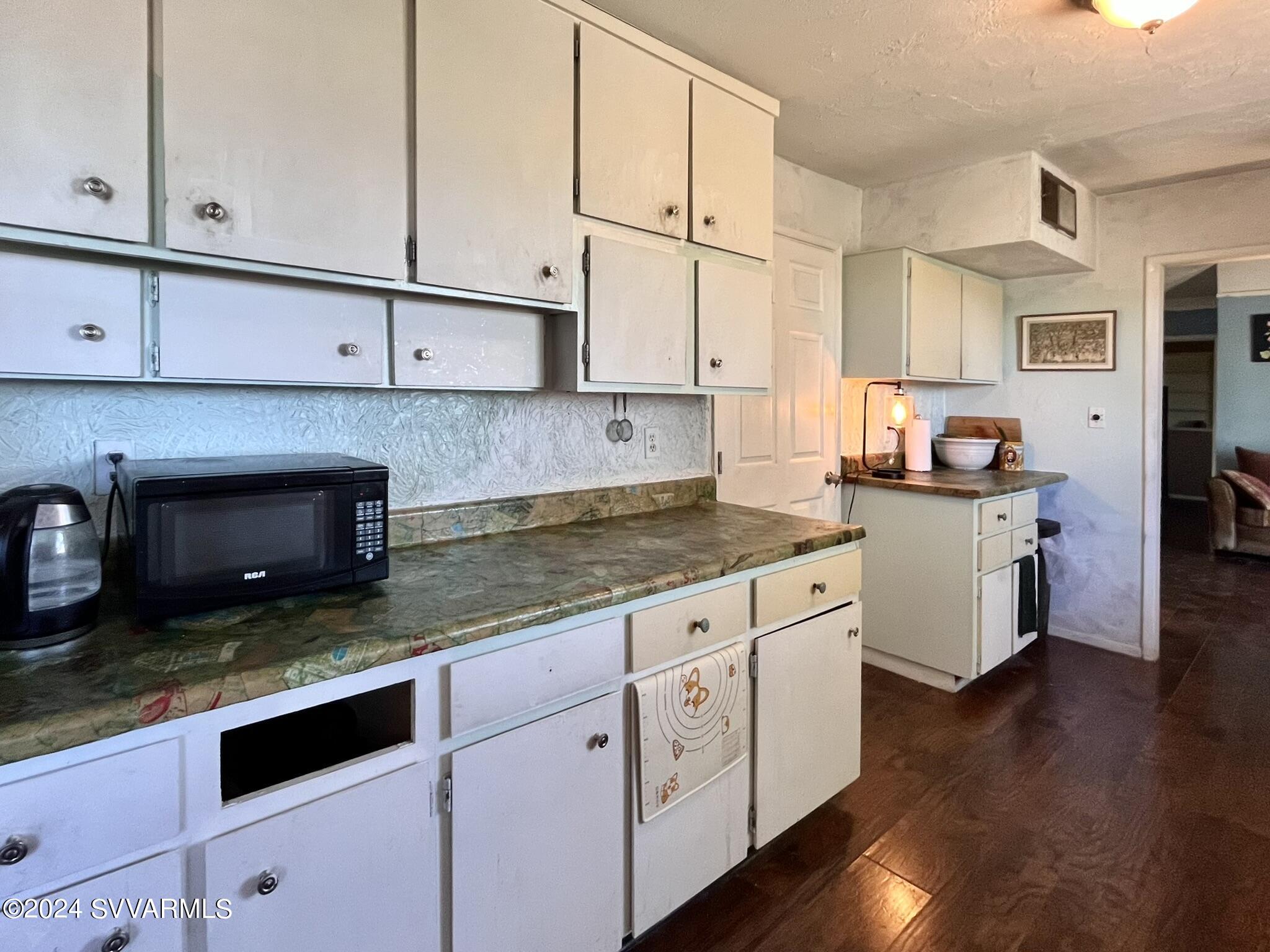 4545 North Drifting Sands Road Rimrock, AZ 86335 - Photo 21 of 52 a kitchen with granite countertop white cabinets and white appliances