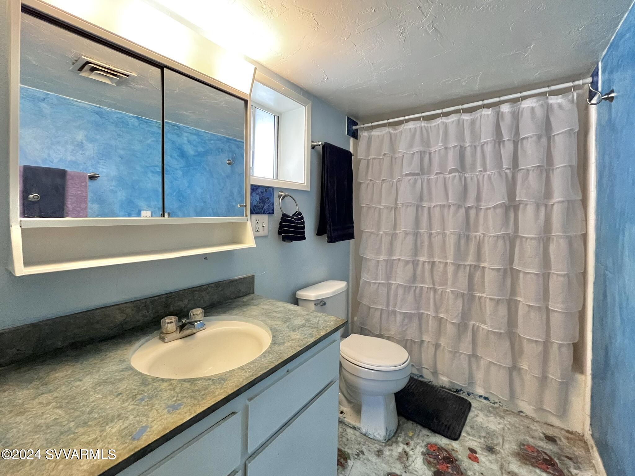 4545 North Drifting Sands Road Rimrock, AZ 86335 - Photo 26 of 52 a bathroom with a granite countertop sink and a mirror