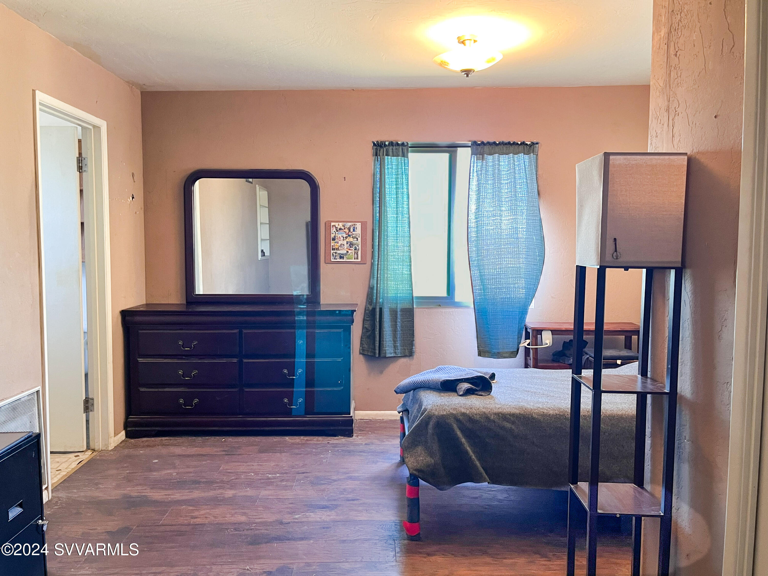 4545 North Drifting Sands Road Rimrock, AZ 86335 - Photo 27 of 52 a bedroom with a bed and a mirror