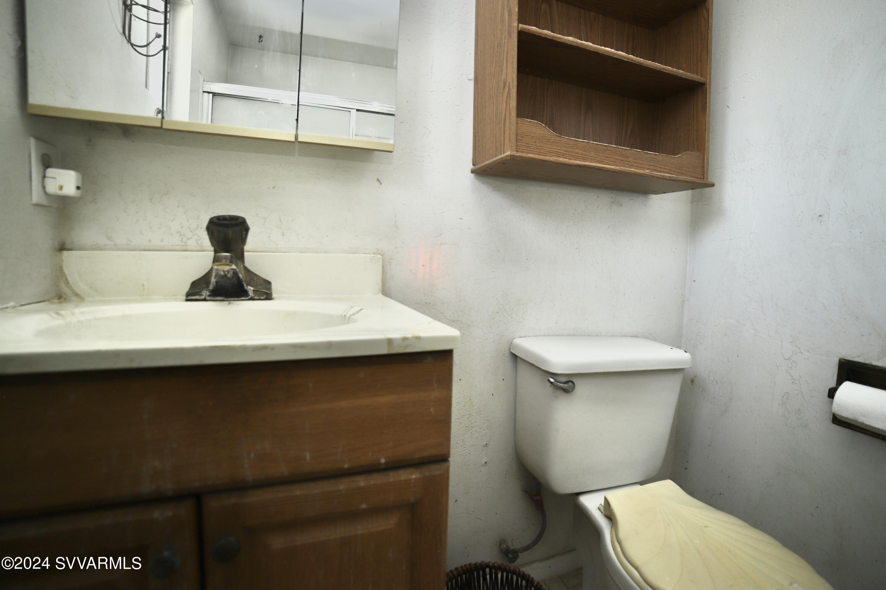 4545 North Drifting Sands Road Rimrock, AZ 86335 - Photo 31 of 52 a bathroom with a toilet a sink and a mirror