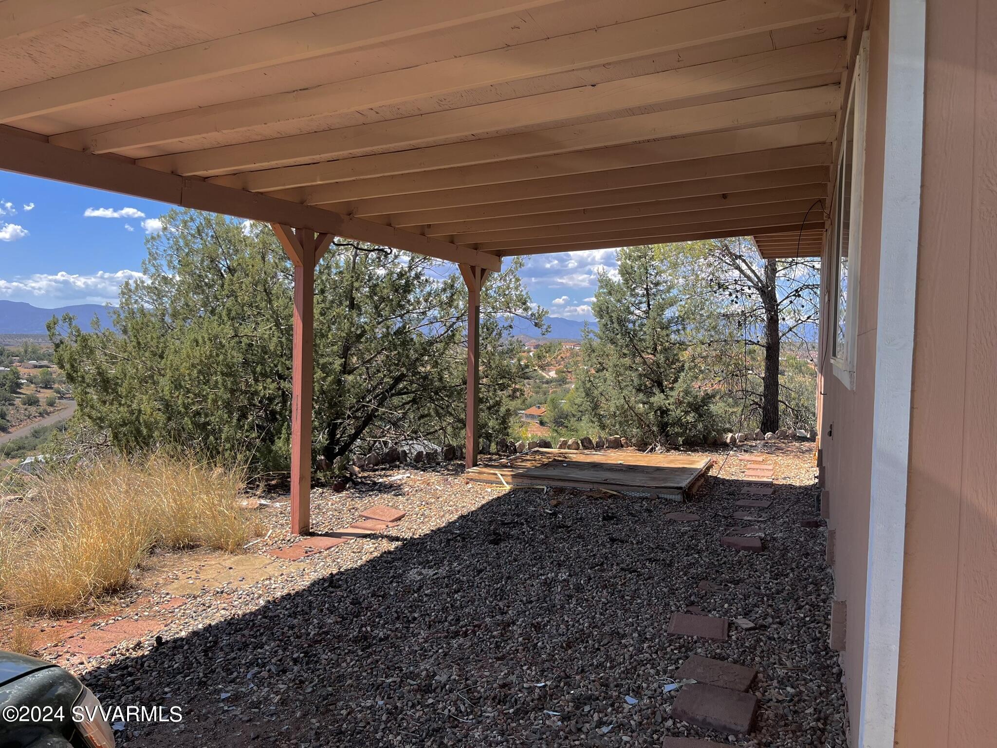 4545 North Drifting Sands Road Rimrock, AZ 86335 - Photo 45 of 52 a view of a backyard with large trees and a lawn chairs