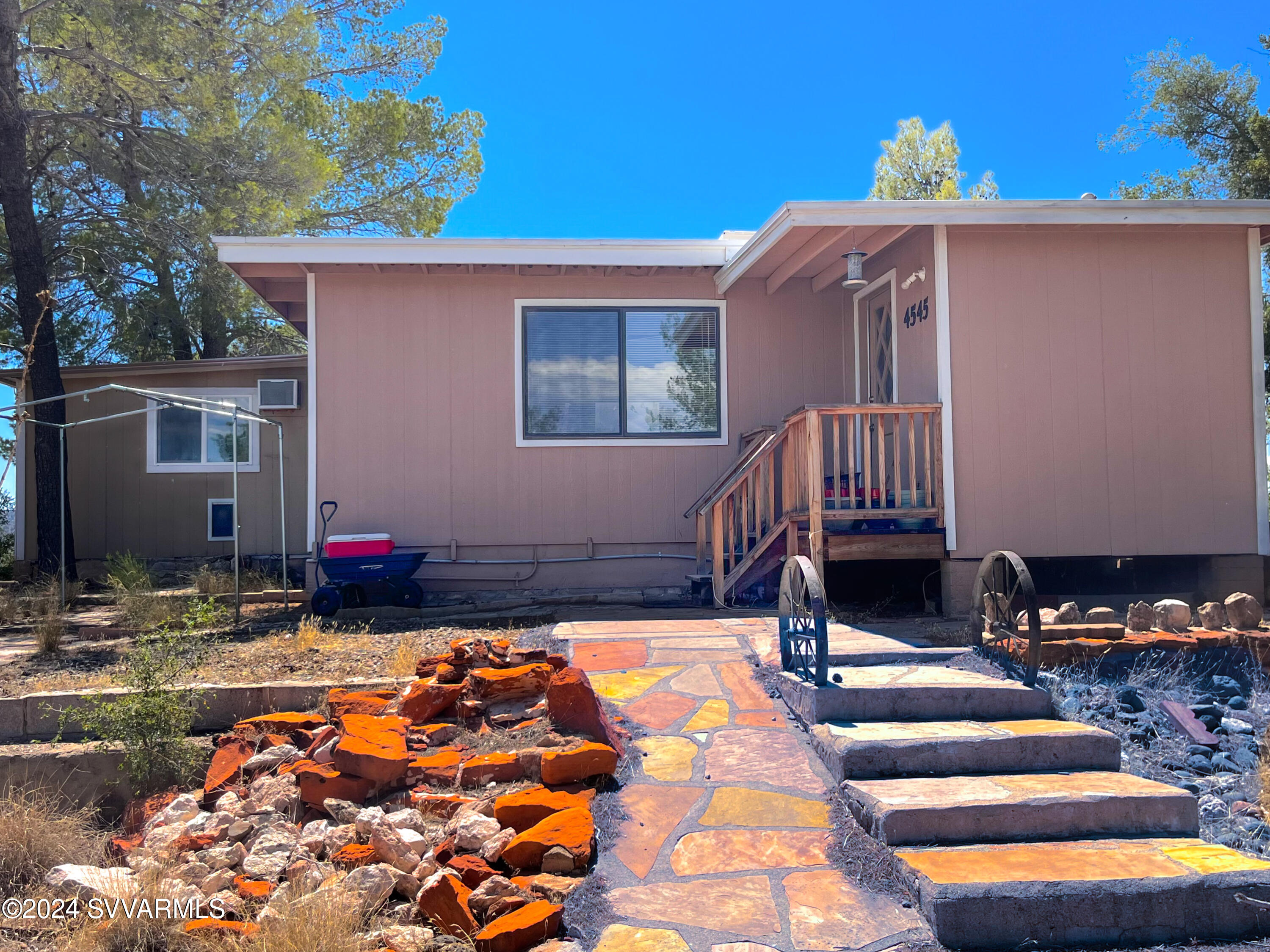 4545 North Drifting Sands Road Rimrock, AZ 86335 - Photo 49 of 52 a backyard of a house with barbeque oven table and chairs