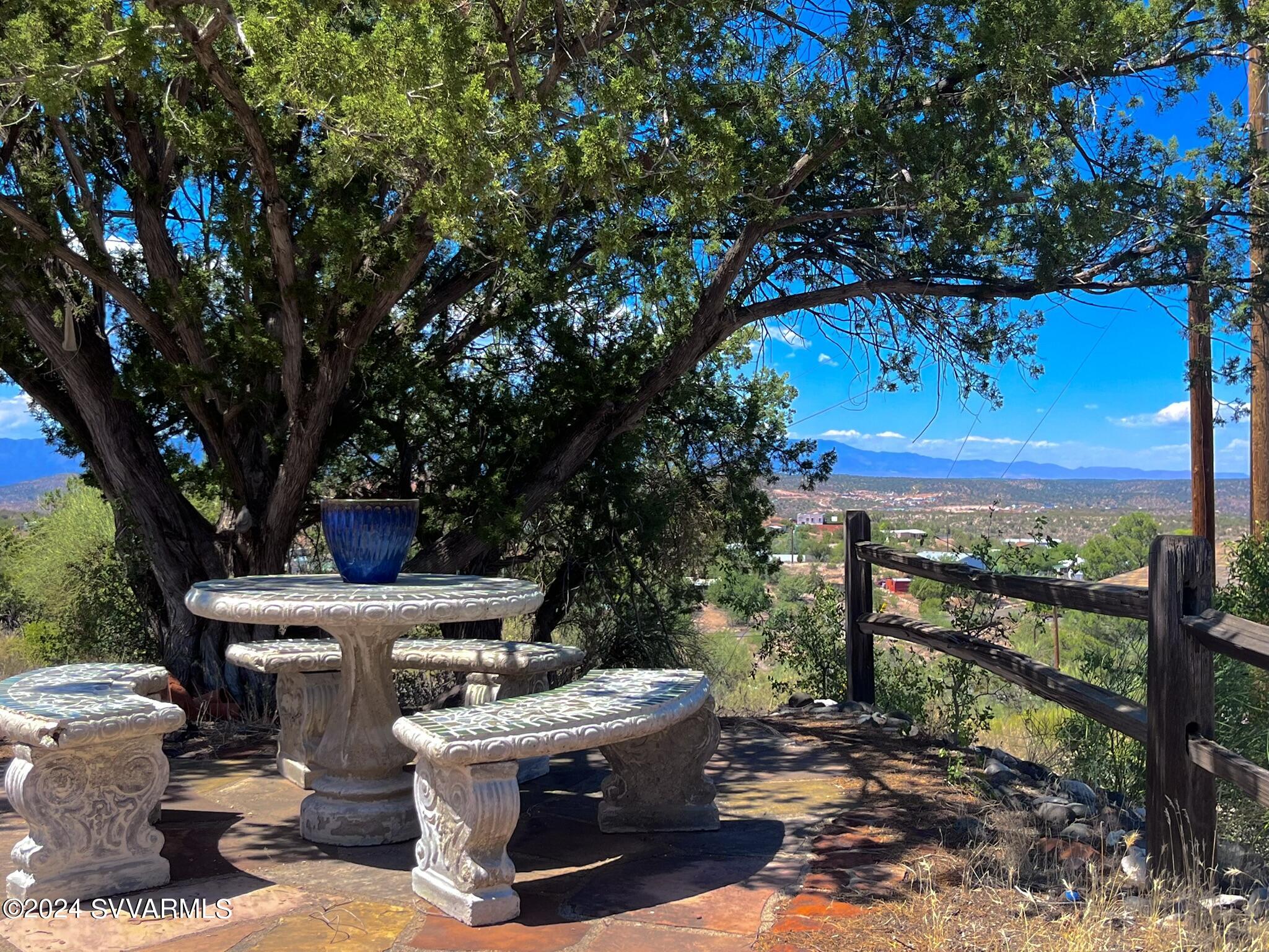 4545 North Drifting Sands Road Rimrock, AZ 86335 - Photo 8 of 52 a view of a patio with table and chairs plants and large trees