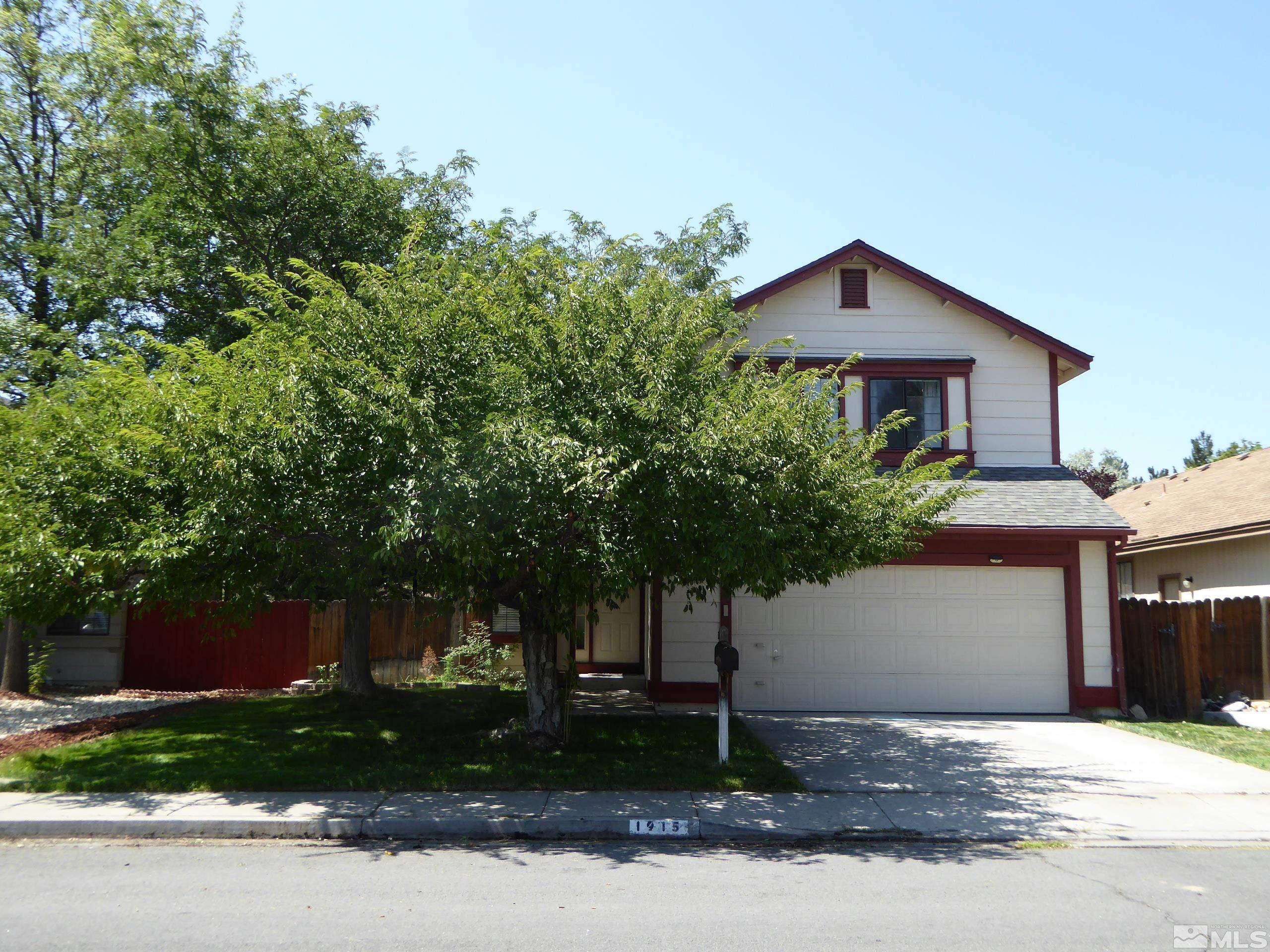 1915 Amarak Way Reno, NV 89523 - Photo 1 of 25 a front view of a house with a yard and a garage