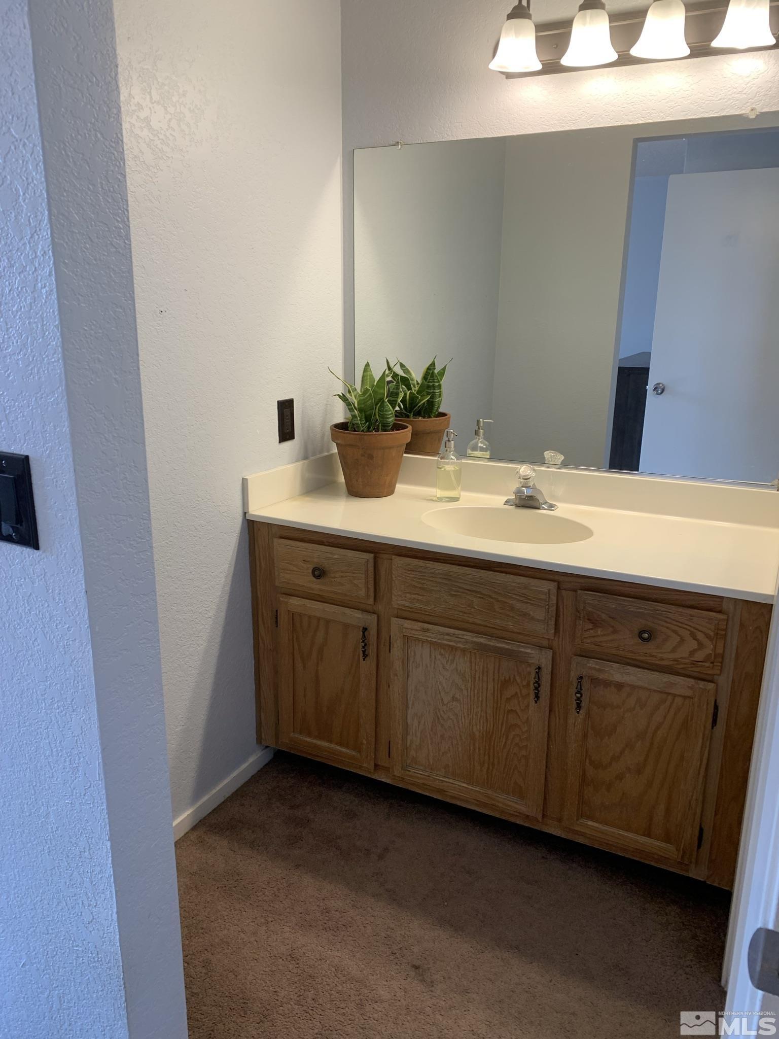 1915 Amarak Way Reno, NV 89523 - Photo 13 of 25 a bathroom with a sink and a mirror