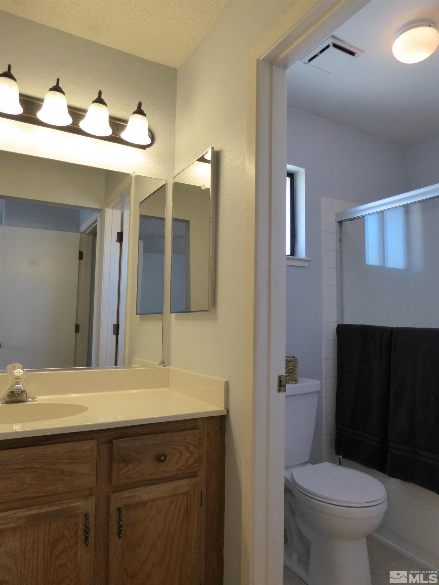 1915 Amarak Way Reno, NV 89523 - Photo 14 of 25 a bathroom with a sink and a mirror