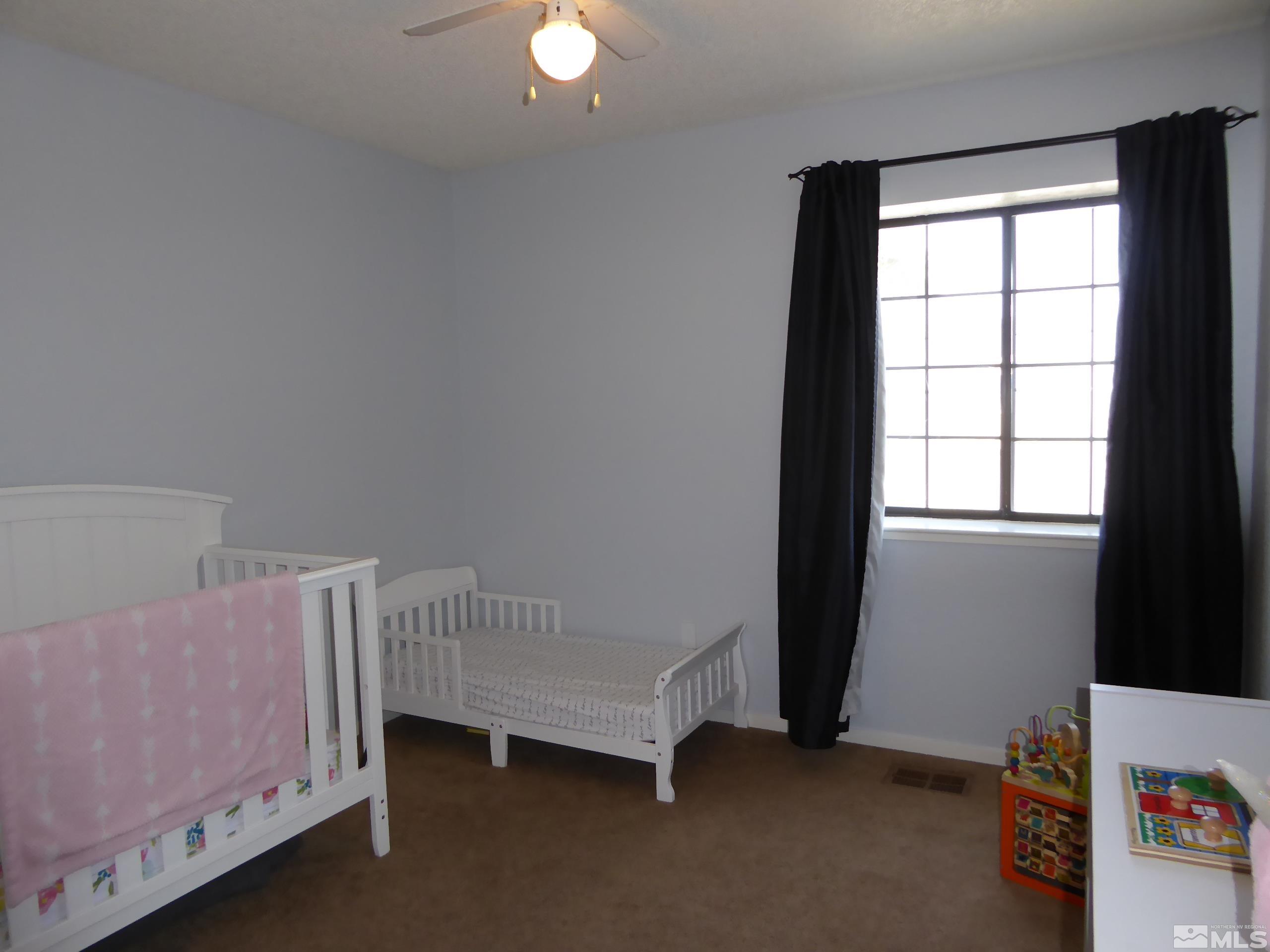 1915 Amarak Way Reno, NV 89523 - Photo 17 of 25 a room with a baby bed