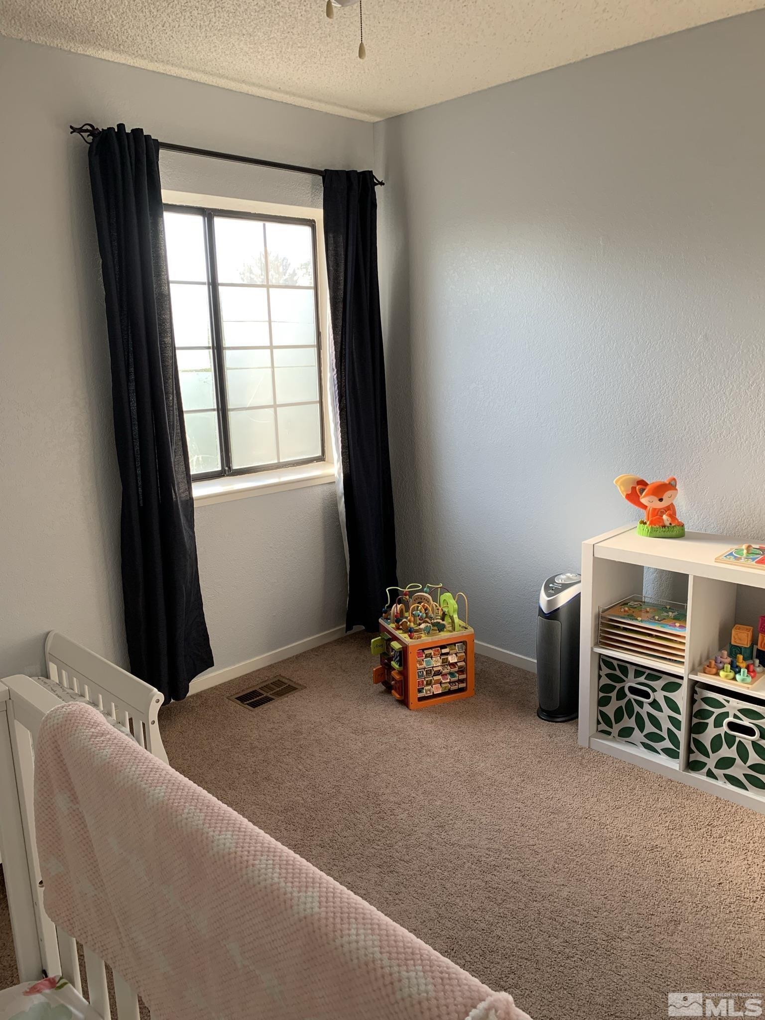 1915 Amarak Way Reno, NV 89523 - Photo 18 of 25 a room with furniture and a window