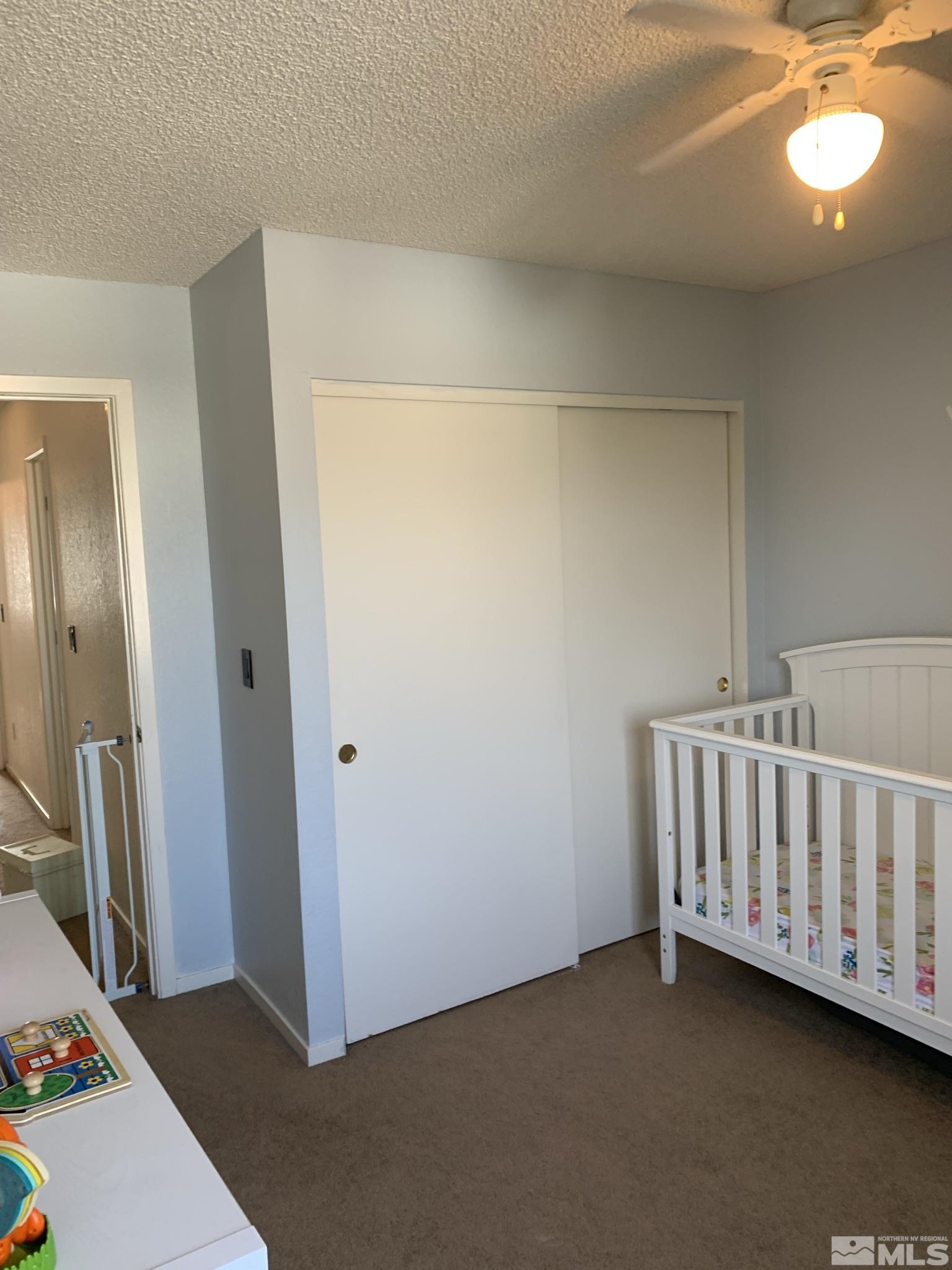 1915 Amarak Way Reno, NV 89523 - Photo 19 of 25 a view of a room with a baby crib