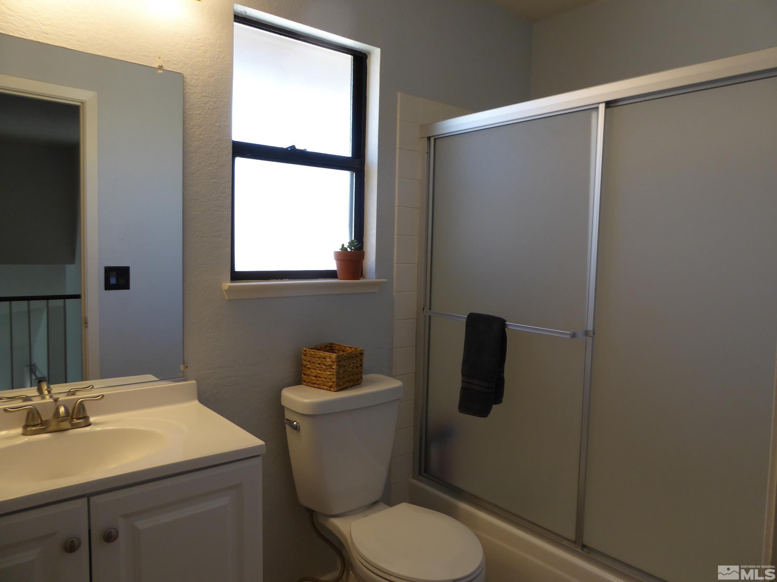 1915 Amarak Way Reno, NV 89523 - Photo 20 of 25 a bathroom with a toilet sink and mirror