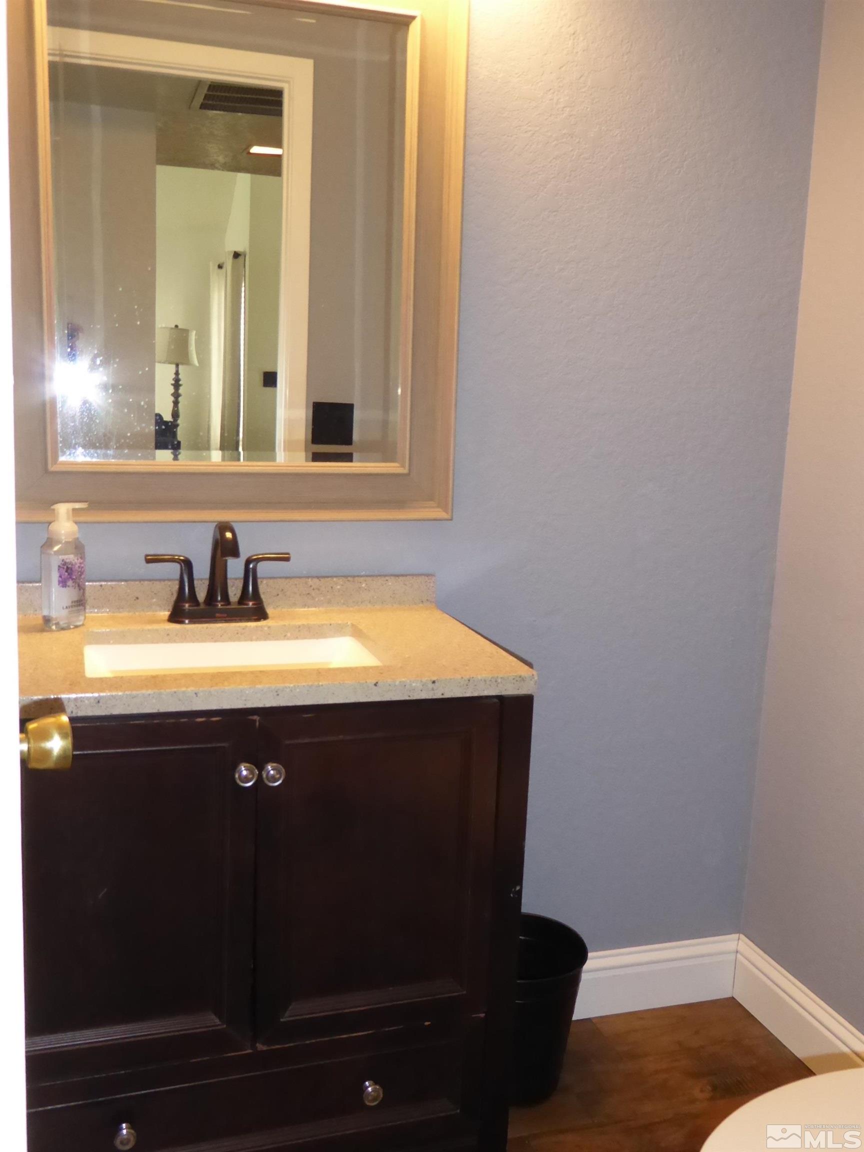 1915 Amarak Way Reno, NV 89523 - Photo 21 of 25 a bathroom with a sink vanity and mirror
