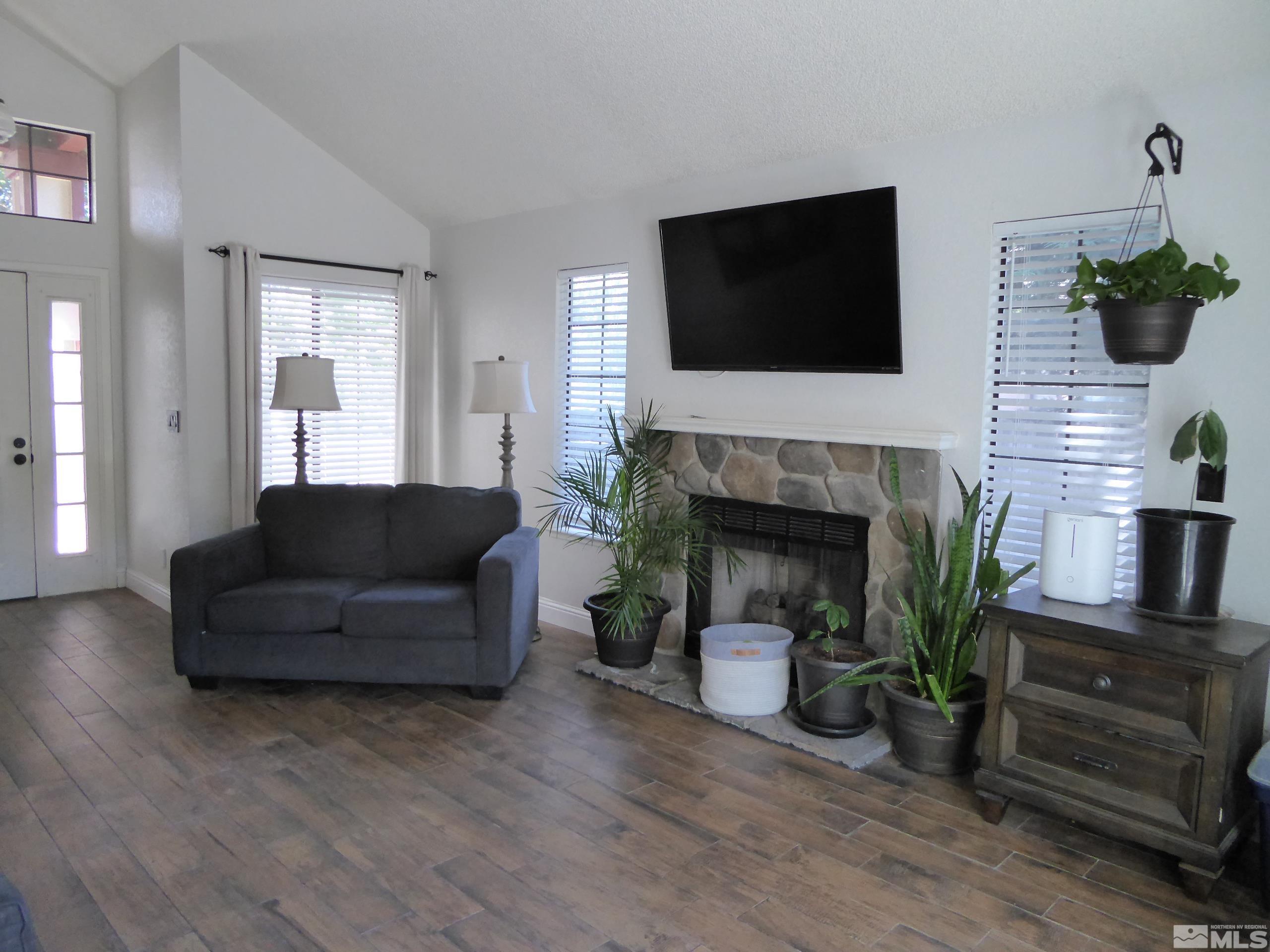 1915 Amarak Way Reno, NV 89523 - Photo 3 of 25 a living room with furniture fireplace and flat screen tv