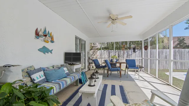 a living room with furniture a fireplace and a floor to ceiling window