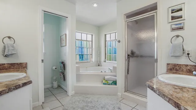 a bathroom with a granite countertop sink a toilet and shower