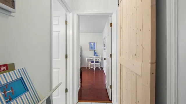 a view of a hallway with a livingroom and a hallway