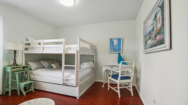 a bedroom with a bed and a chair in it