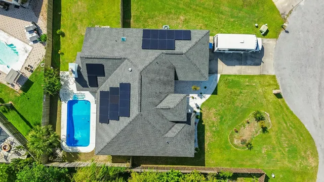 an aerial view of a house with a swimming pool