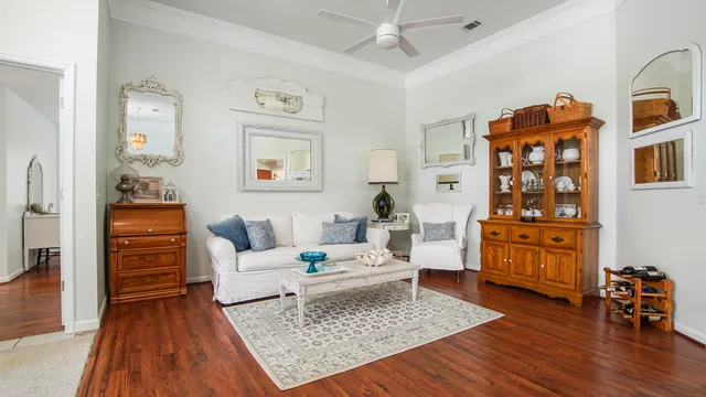 a living room with furniture and wooden floor