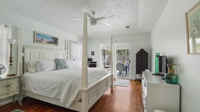 a spacious bedroom with a bed a couch and a large window