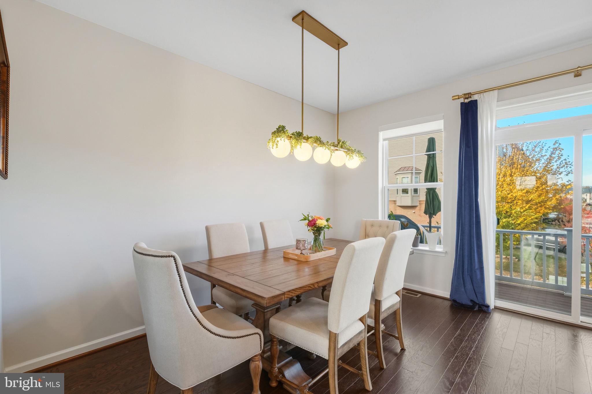 15635 Trolley Lane Silver Spring, MD 20906 - Photo 12 of 41 a view of a dining room with furniture wooden floor and a chandelier