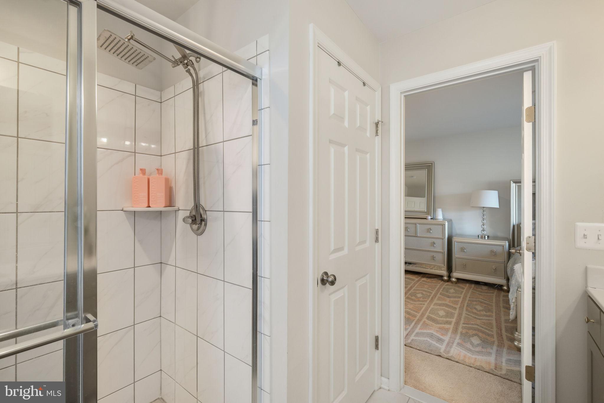 15635 Trolley Lane Silver Spring, MD 20906 - Photo 23 of 41 a bathroom with a shower and a glass door